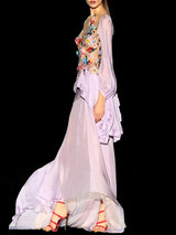 a woman in a white dress holding a tennis racket