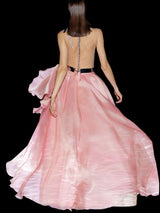 a woman in a pink dress holding a pink purse