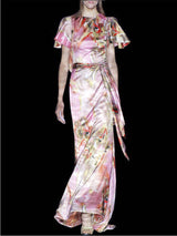 a woman in a pink dress holding a glass