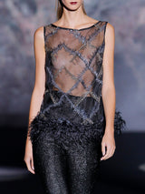 Blusa en organza bordada con cristales decorada con plumas en el bajo y pantalon pitillo en gran pique con lurex de Hannibal Laguna