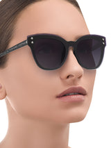 a woman wearing sunglasses is wearing sunglasses
