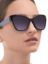 a woman wearing sunglasses and a hat and sunglasses