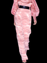 a woman in a pink dress holding a cell phone