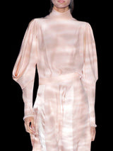 a woman in a white dress holding a purse