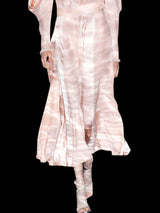 a woman in a white dress holding an umbrella