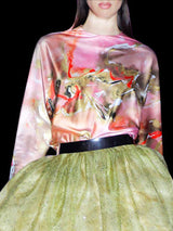 a woman in a pink dress standing next to a bed