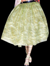 a woman in a white dress holding an umbrella