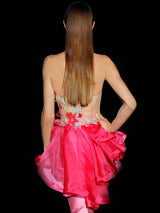 a woman in a pink dress holding a pink purse