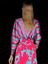 a woman in a red and white dress holding a cell phone