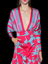 a woman in a red dress holding a cell phone