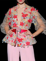 a woman in a pink dress holding a cell phone