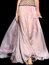 a woman in a pink dress standing in a room